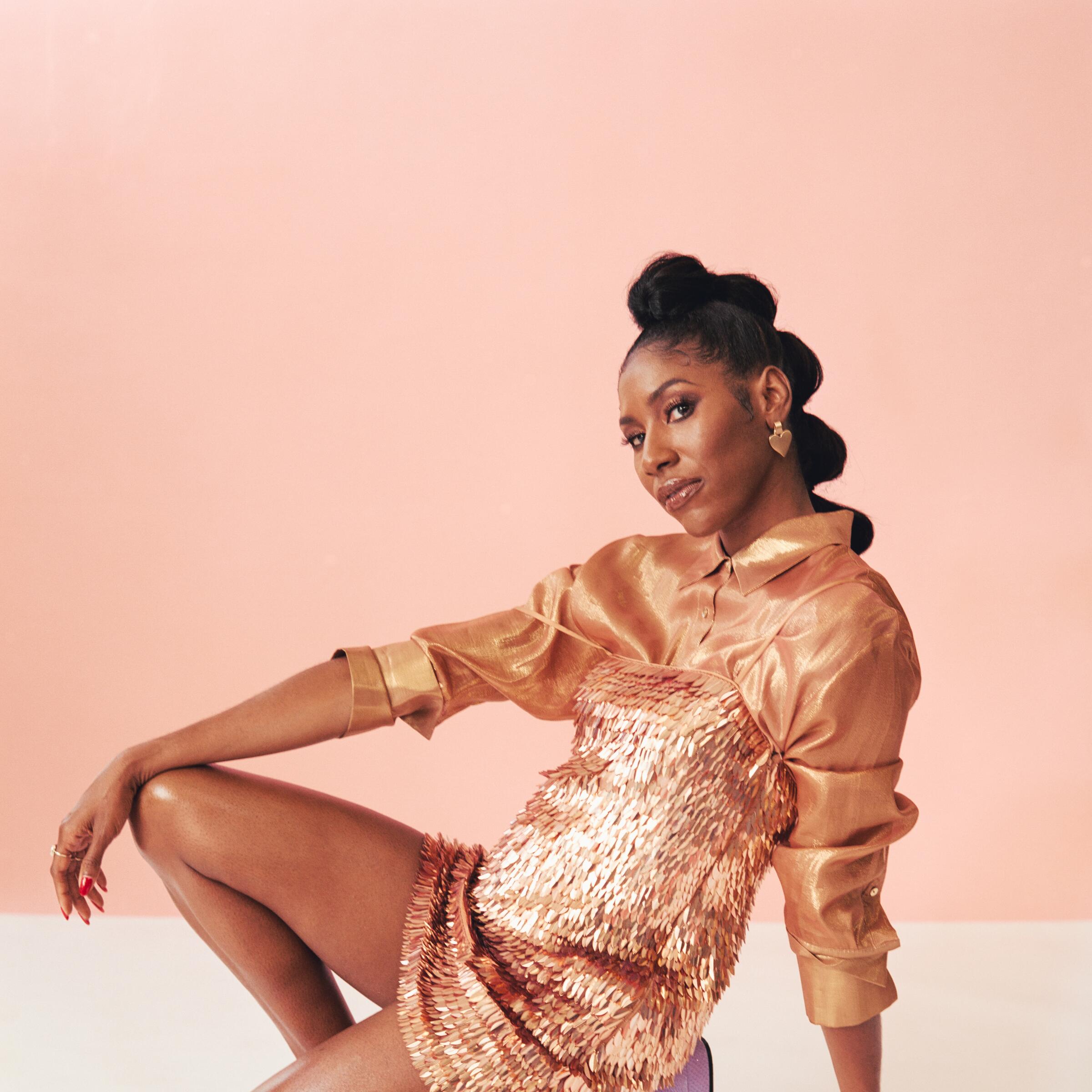 Diarra Kilpatrick crouches on one knee for a portrait.