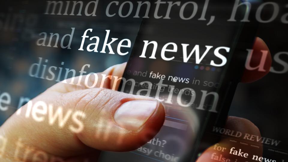 Titles on screen in hand with fake news and hoax information 3d illustration