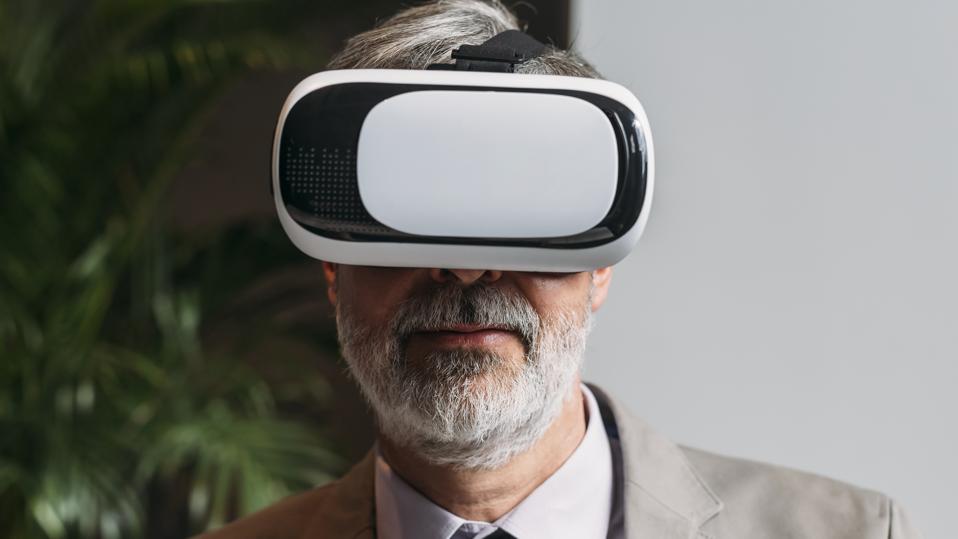 Man in suit wearing an Oculus VR headset