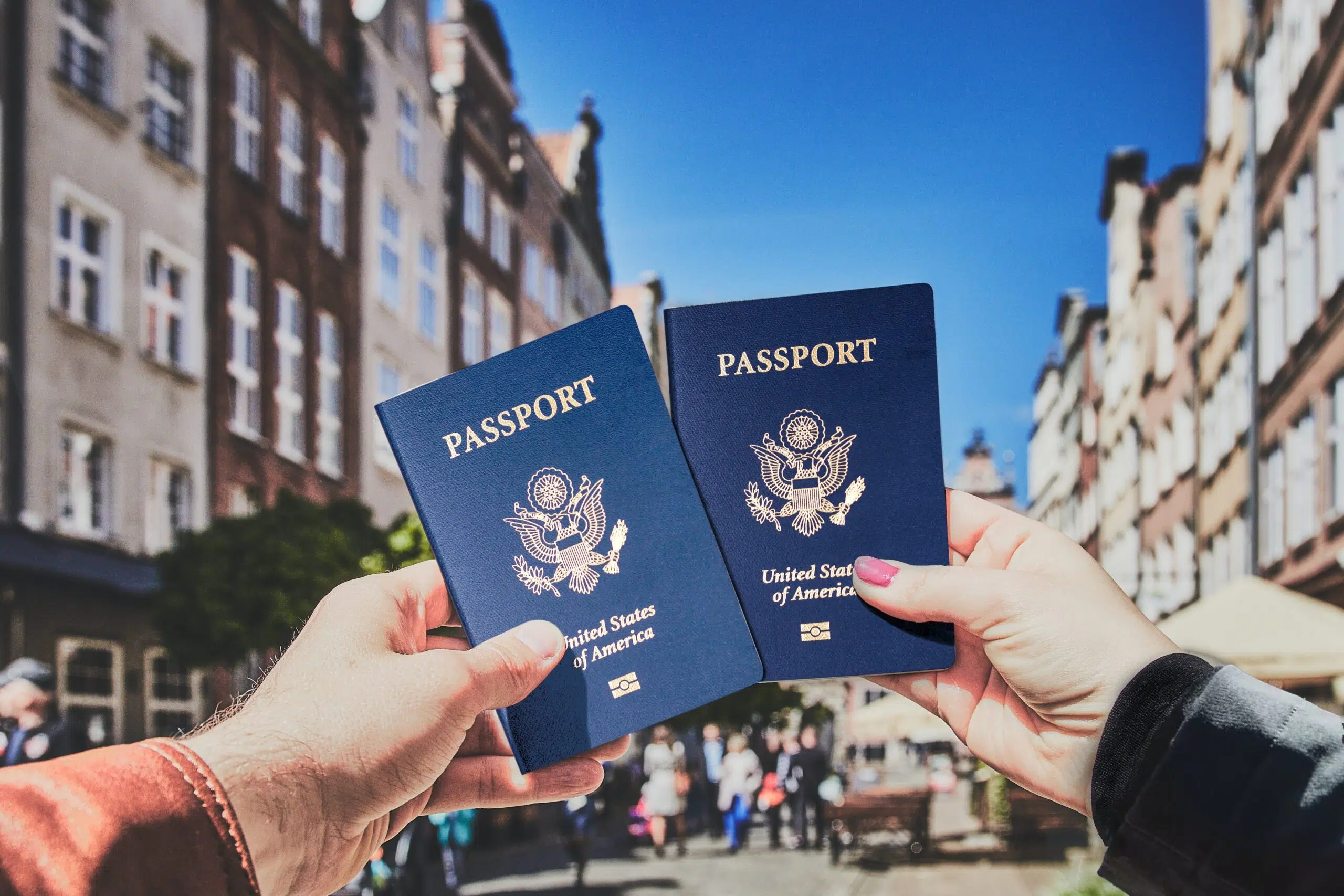 couple holding up their US passports