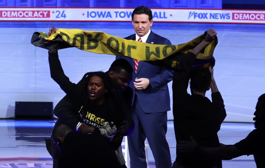 Protesters interrupt Republican presidential candidate Florida Governor Ron DeSantis during a Fox News Town Hall on January 09, 2024 in Des Moines, Iowa.