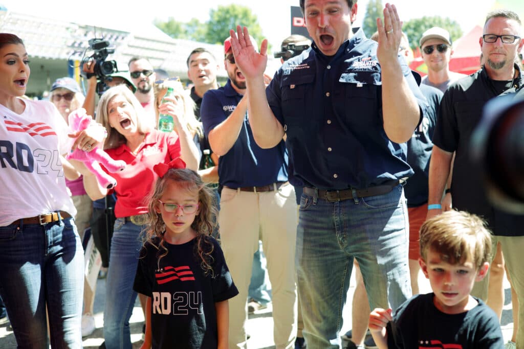 Republican U.S. presidential candidate and Florida Governor Ron DeSantis and his wife Casey celebrate as they watch their children Madison and Mason playing carnival games at the Iowa State Fair midway on August 12, 2023 in Des Moines, Iowa.