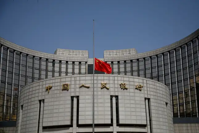 The Chinese national flag flies at half-mast at the headquarters of the People's Bank of China