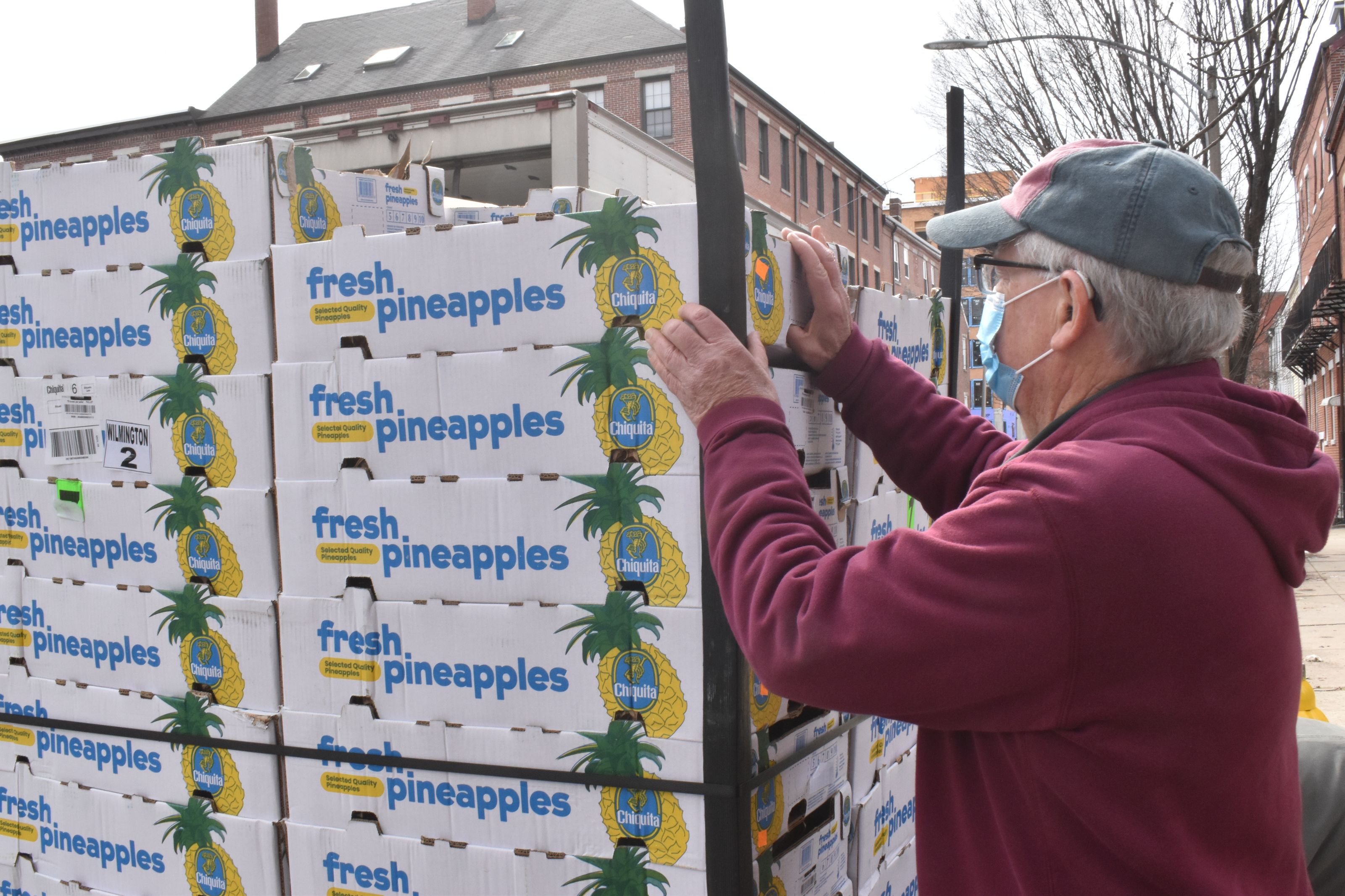 A shipment of pineapples arrives on a Monday morning, March 15, 2022 at East Boston Community Soup Kitchen. The next day, the hours spent unloading and packaging them today will go by in a flash tomorrow as they're distributed to hundreds (photo credit: Elena Eberwein).