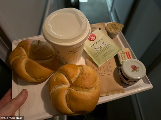 Carlton's complimentary couchette breakfast - a sachet of milk and a tea bag, a small stick of butter, two crusty rolls and a mini pot of jam