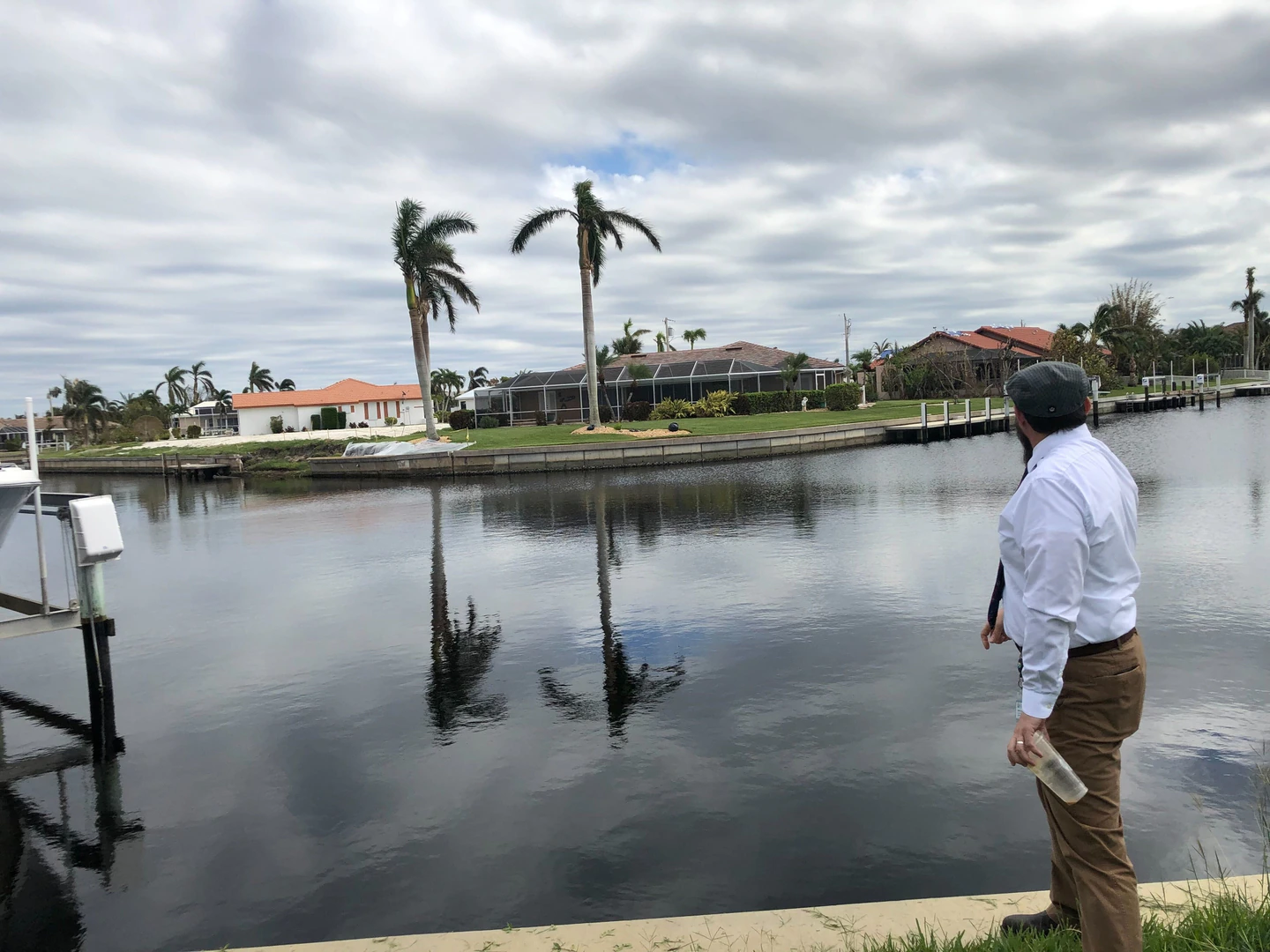 Mitchell Austin looks across one of Punta Gorda’s many canals to a collapsed portion of sea wall on Oct. 20.