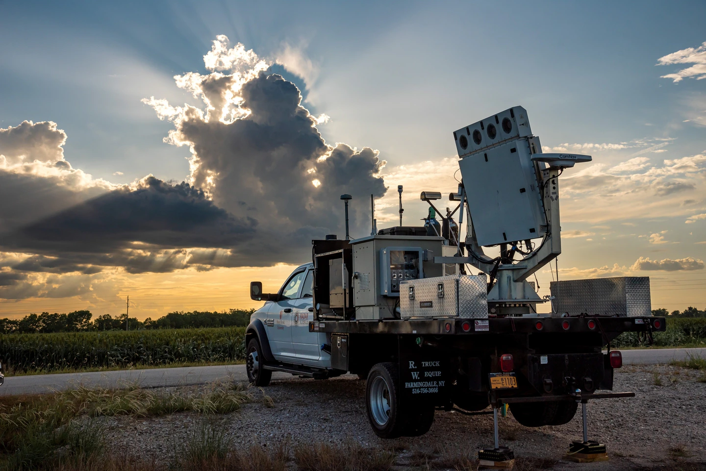 An image of a truck in front of a sunset.