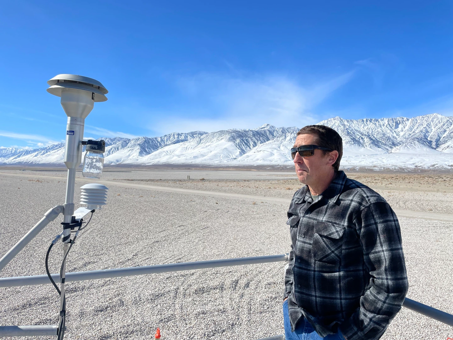 Phillip Kiddoo, the pollution control officer for the region that includes Owens Lake in California, atop an air quality monitoring station at the lake on February 28.