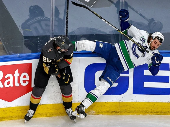 Chandler Stephenson of the Vegas Golden Knights knocks Chris Tanev of the Vancouver Canucks over during Game 2 of their playoff series on Tuesday night, but the Canucks bounced back to tie the best-of-seven series with a 5-2 victory at Rogers Place in Edmonton.