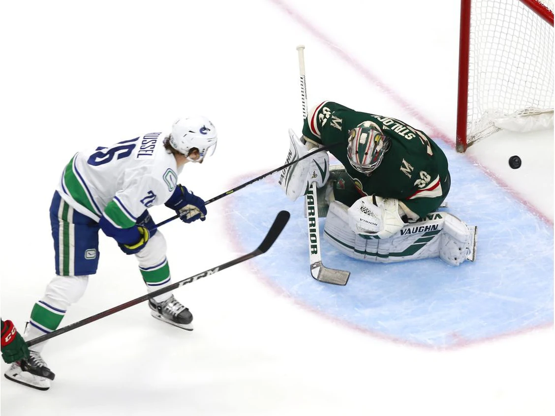 Antoine Roussel scores on Wild goalie Alex Stalock to put the Canucks up 2-0. Photo by Jeff Vinnick /Getty Images