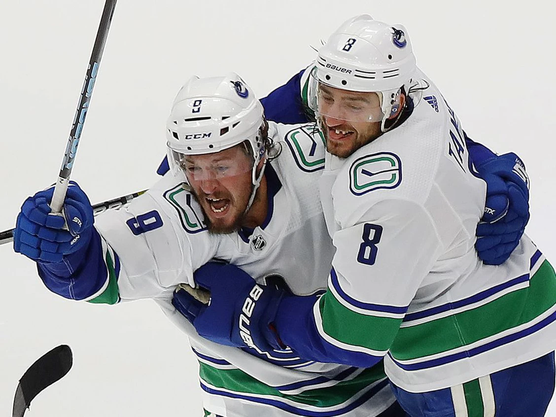 Canucks defensemen Chris Tanev (right) celebrates with J.T. Miller after Tanev scored the series winning goal against the Minnesota Wild. Photo by Perry Nelson /USA TODAY Sports