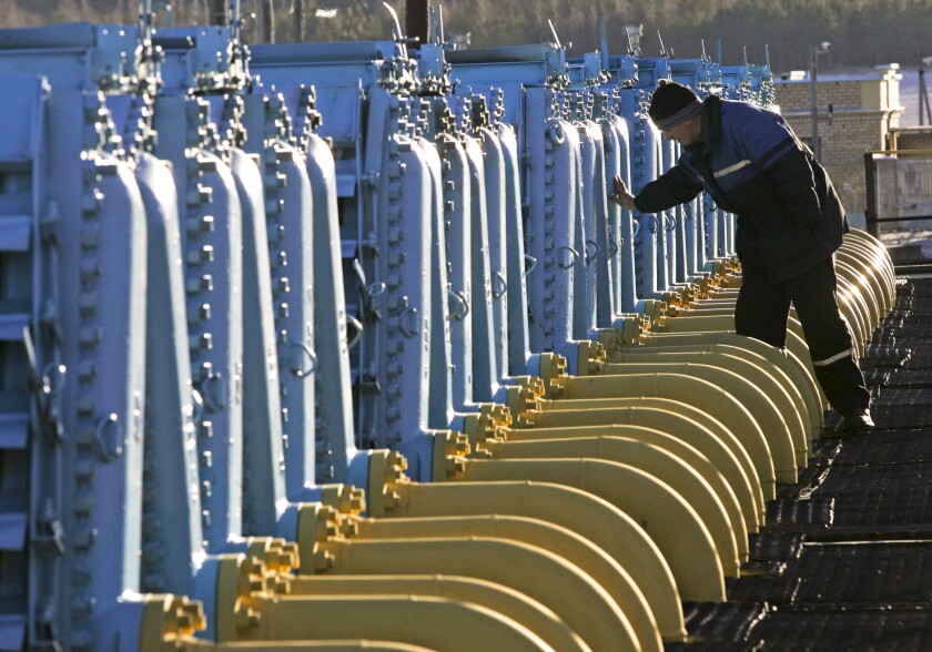 A worker checking equipment at a pipeline