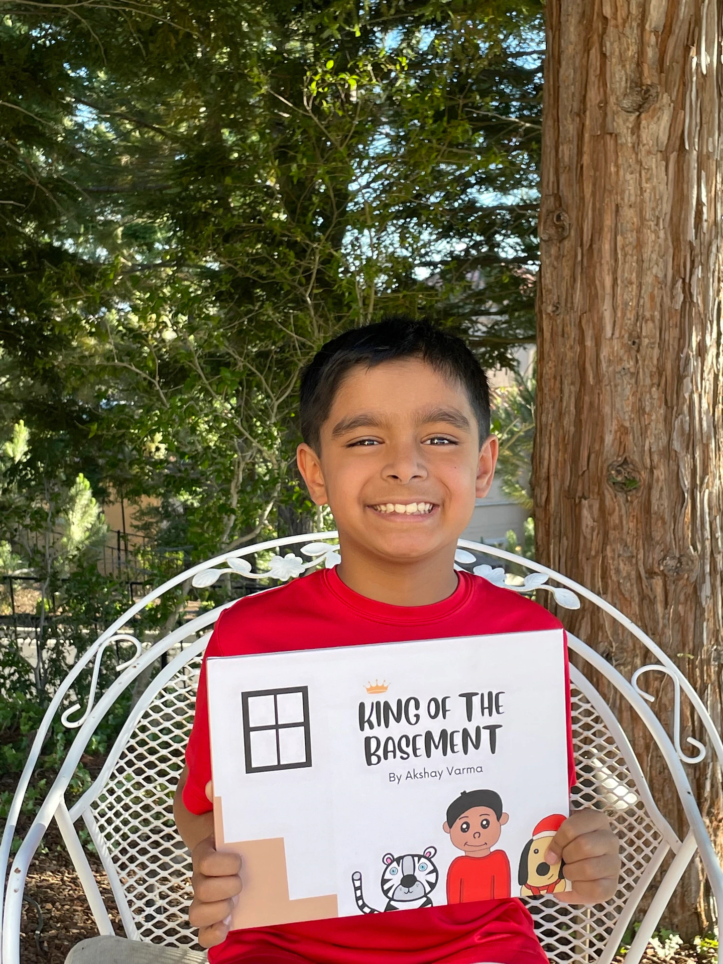 Akshay Varma holds a children's book he wrote about his experience with long covid.