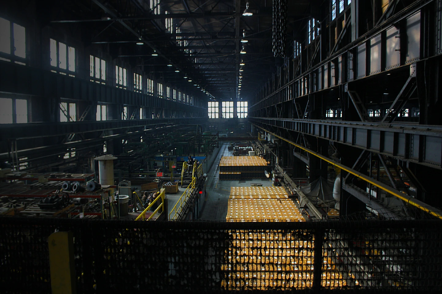 From a wide angle, image shows the factory from inside, with cases and cases of shells.