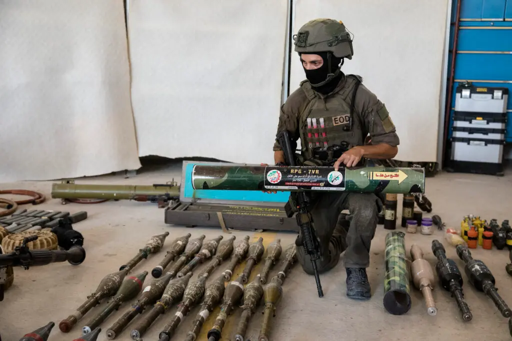 An Israeli soldier displays a Hamas made RPG during a presentation of military equipment and ammunition that Hamas and Palestinian militants used in Oct. 7 attacks.