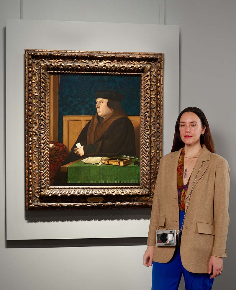artist Jenna Gribbons in front of a Hans Holbein portrait at the Frick Madison
