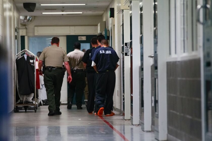 SAN DIEGO, CA-NOVEMBER 18, 2015: | Sheriff's Deputies escorts inmates down a secured hallway at downtown Central Jail. | (Nelvin C. Cepeda / San Diego Union-Tribune)