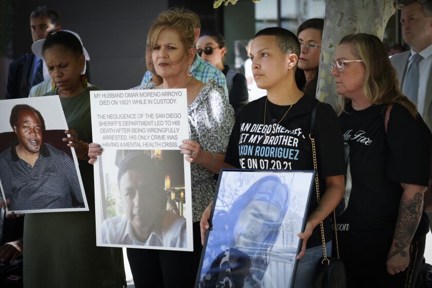 San Diego, CA - August 11: At Federal Courthouse on Thursday, Aug. 11, 2022 in San Diego, CA. those who lost family members while in custody at the San Diego County Jail, held photos of their love ones during a press conference. Left-to-right, Shawn Mills, Tammy Wilson, Sabrina Weddle and Sundee Weddle. Photos l-r, Kevin Mills died in San Diego County Jail Nov 11 2020, Omar Moreno Arroyo, died while in custody January 6, 2021 and Saxon Rodriguez, died while in custody on July 20, 2021. (Nelvin C. Cepeda / The San Diego Union-Tribune)
