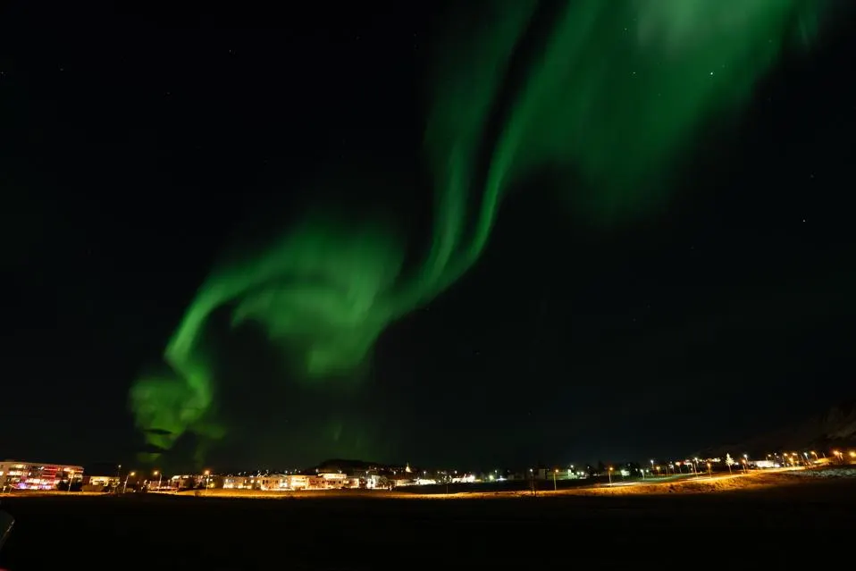 REYKJAVIK, ICELAND - JANUARY 11: A powerful geomagnetic storm triggered vivid Northern Lights lit up the night sky around the Hallgrimskirkja Cathedral in Reykjavik, Iceland on January 11, 2026. Despite the beauty, the arrival of a geomagnetic storm can be a threat to electricity supplies