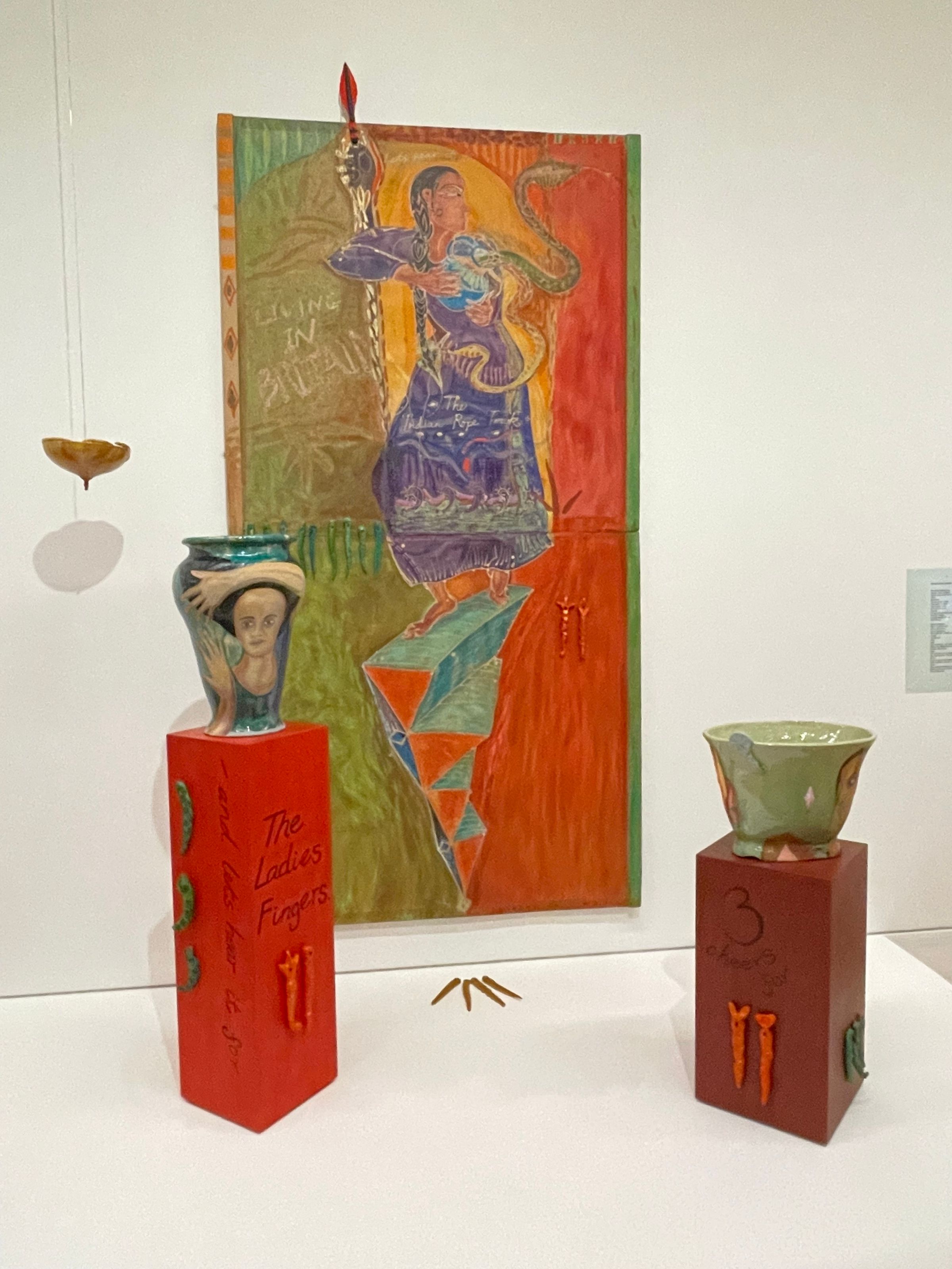 Nina Edge. Snakes and Ladders (1985), remade 2023. Batik on paper mounted on board, ceramics, string, wooden plinths, printed text on paper, laminated.