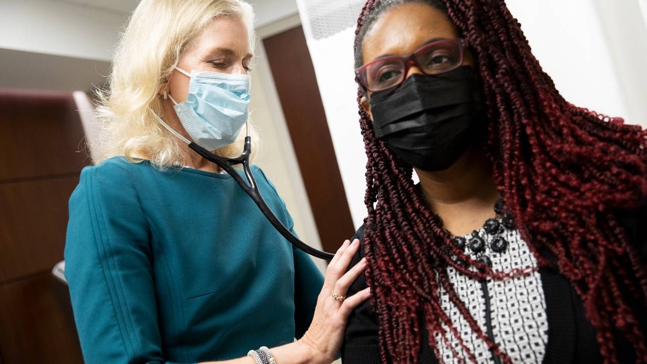 A doctor listening to a patient with a stethoscope. Next Avenue, Postmenopausal hot flashes