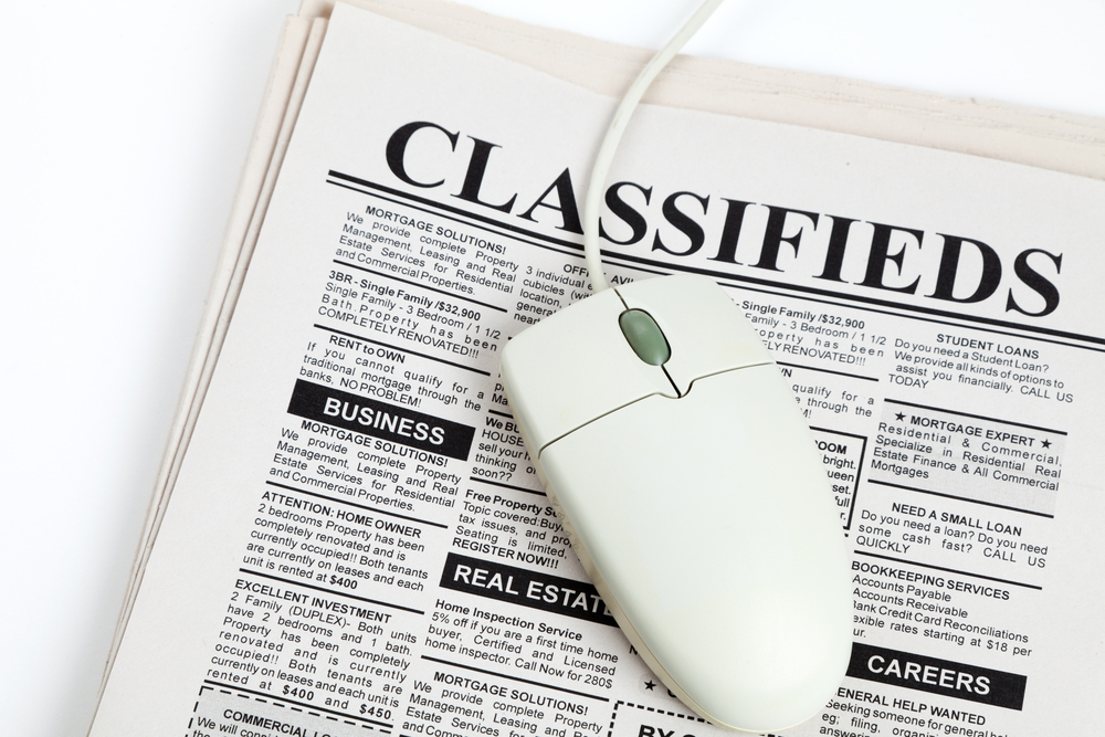 Classified local newspaper advertisement and computer mouse