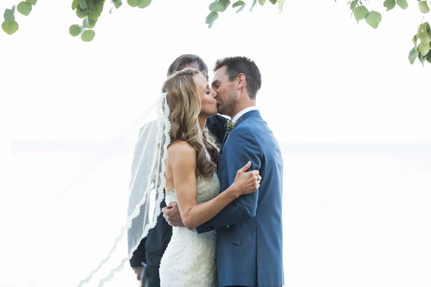 bride-in-pronovias-and-groom-in-ken-baker-kiss-after-being-pronounced-husband-and-wife