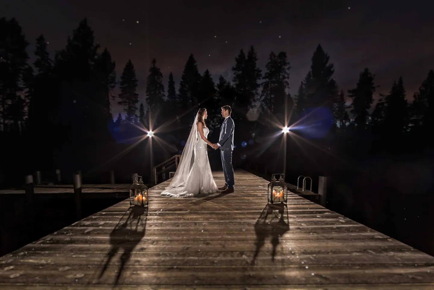 couple-on-dock-night-dusk-small-lights-darkened-background-lake-tahoe-california
