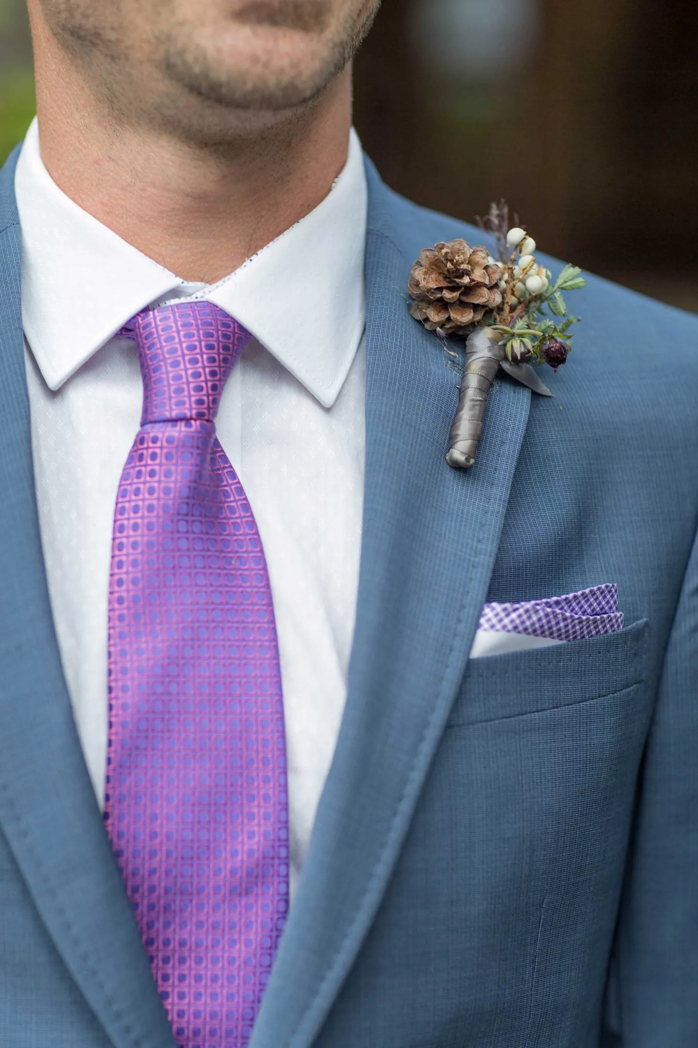 grooms-blue-suit-purple-tie-pocket-square-rustic-boutonniere-patterns-greenery