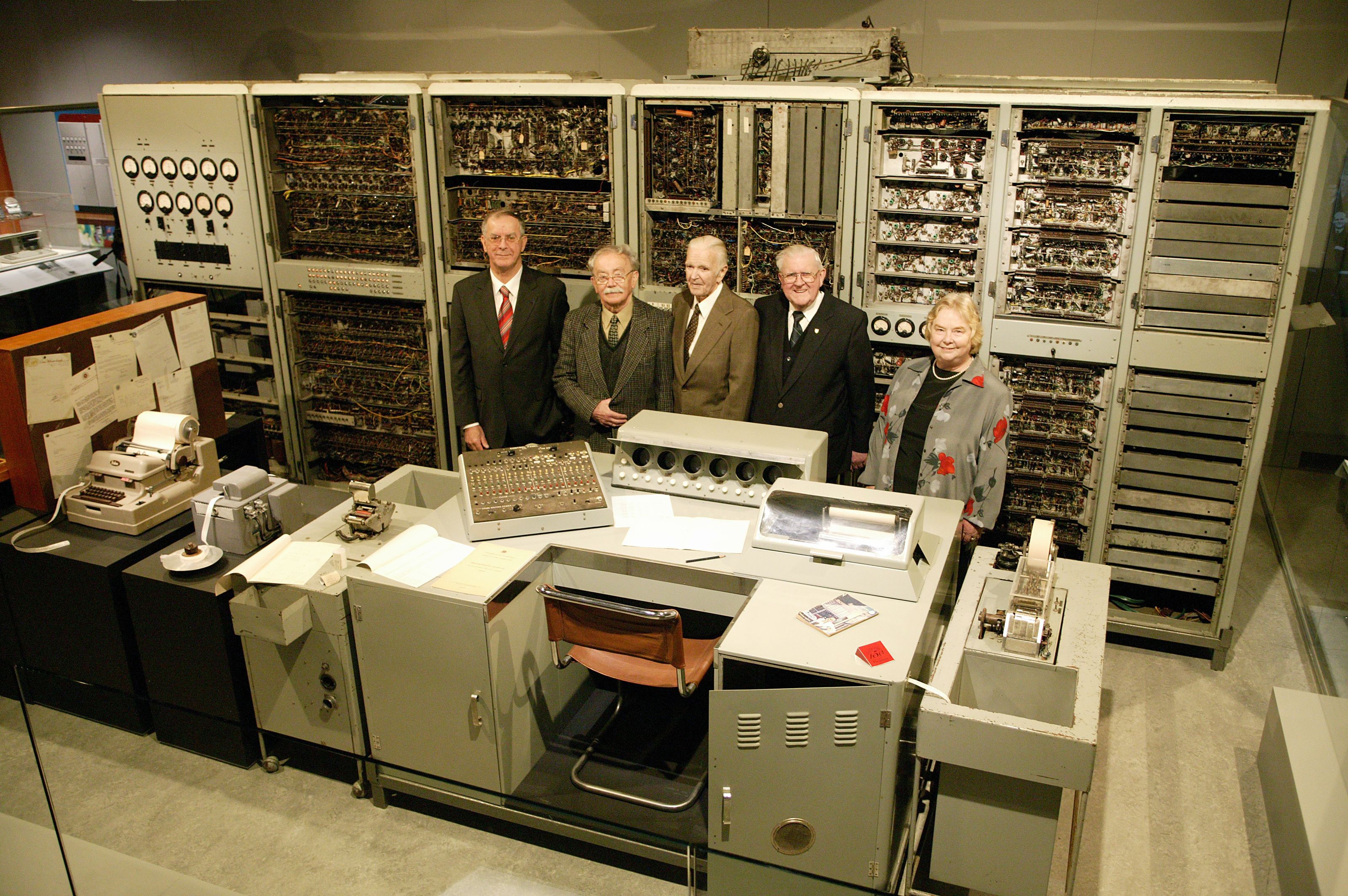 The restored colossus CSIRAC with some of the engineers who worked on it