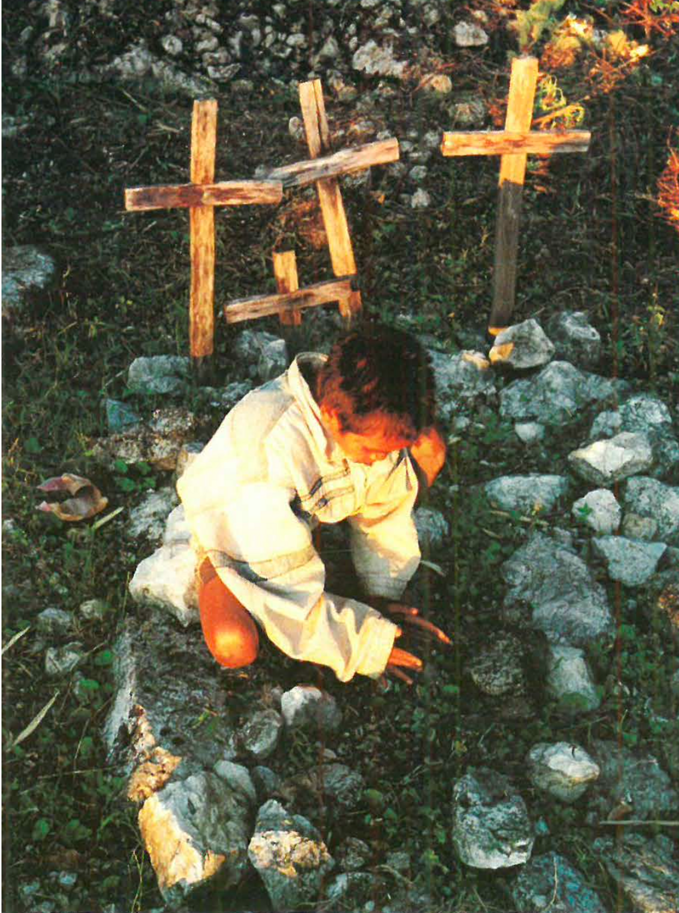 A child tends a grave in Mount Ramelau (Ross Bird)