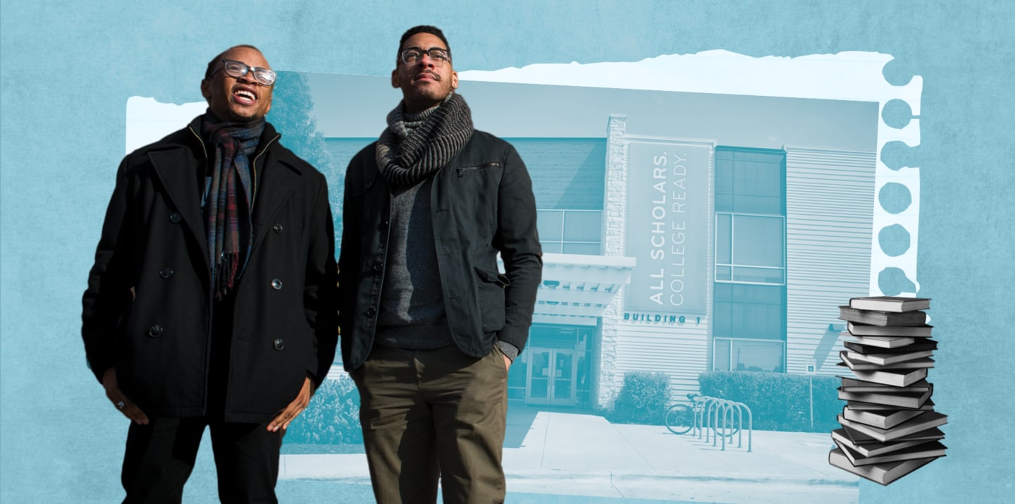 Tamir and Sterling stand in front of school house and stack of books